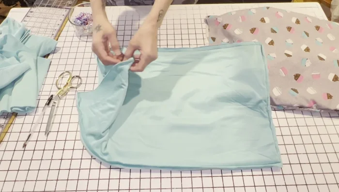 Fold the extra minky/fleece over the top of the flannel sack, enclosing the raw edges. Pin securely.