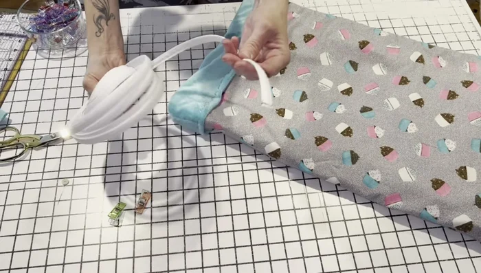 Insert boning through the opening. Stitch across the opening to secure the boning and close the gap. Add an extra stitch line just below the boning to prevent movement.