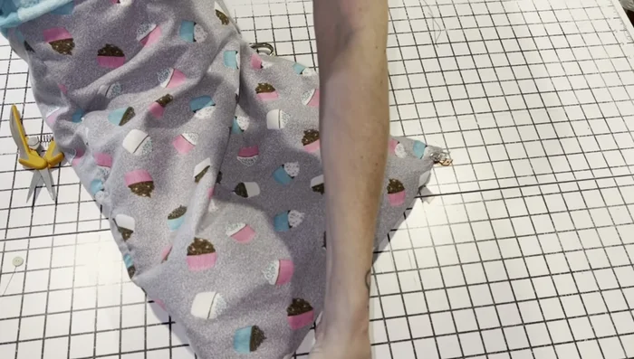 Optional: Add a small stitch in each corner to secure the inner and outer fabric layers more firmly.