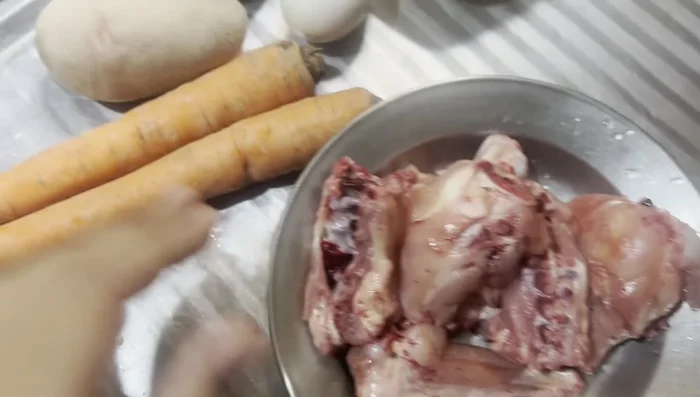 Prepare Ingredients: Clean and cut 1 loaf of chicken wings, 2 carrots, and 2 potatoes (adjust quantity based on the number of days you're preparing the food for). If available, add peas.