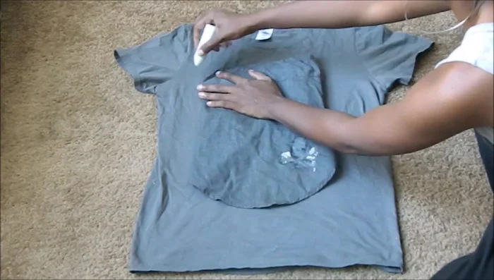 Use an old t-shirt or onesie as a template. Trace the outline onto your new fabric, or use your measurements to create your own pattern. Cut off the sleeves and collar.