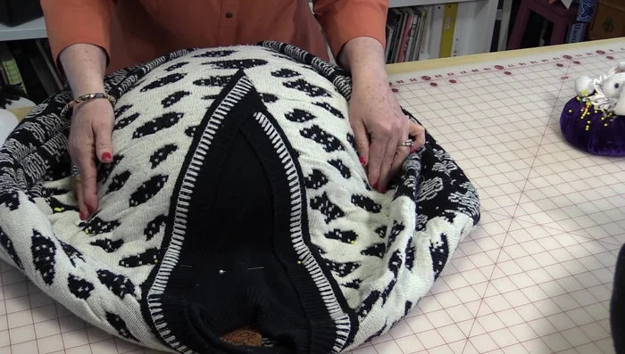 Stitch around the pillow form, creating a half-circle shape. You can hand-sew this step if you prefer.