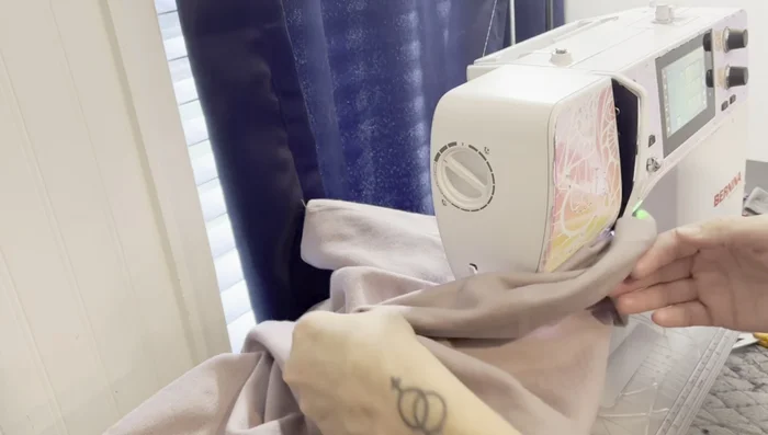 Sew the pocket onto the sweatshirt. Carefully sew the pocket onto the sweatshirt, making sure not to sew the back layer. Sew slowly and avoid bunching up the fabric.