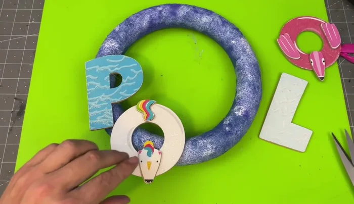 Glue the pool letters to the wreath form.
