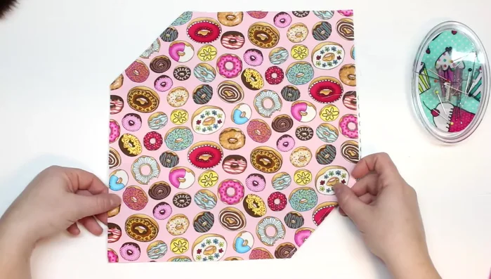 Fold the fabric in half with right sides together, aligning raw edges and corners.