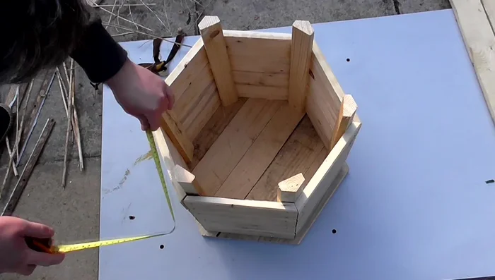 Add the final layer of side pieces and create a bottom panel using the same method as the top panel, screwing from the bottom.