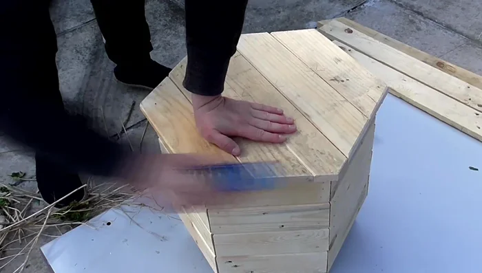 Add the final layer of side pieces and create a bottom panel using the same method as the top panel, screwing from the bottom.