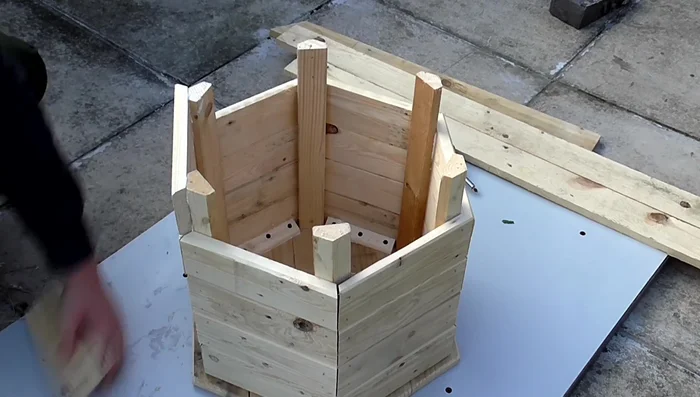 Add the final layer of side pieces and create a bottom panel using the same method as the top panel, screwing from the bottom.