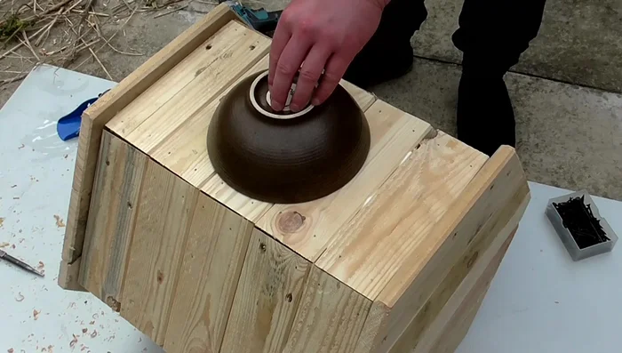 Cut the entrance hole using a dish as a template, drilling a pilot hole then using a jigsaw.