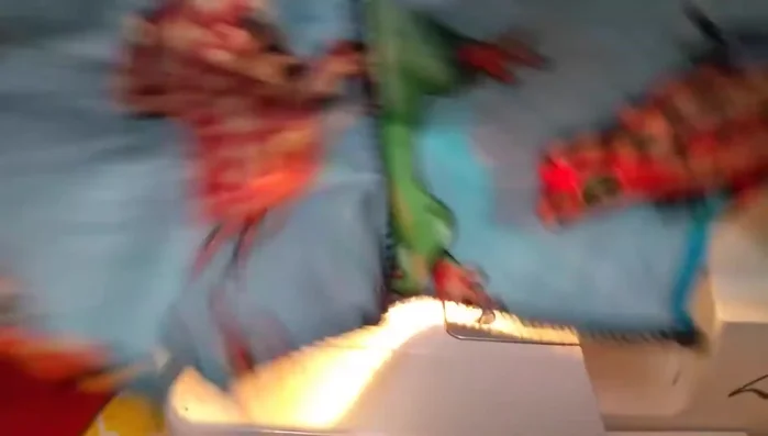 Attach the gathered skirt tiers to the bodice using a serger, placing the ruffle on top for smoother serging.