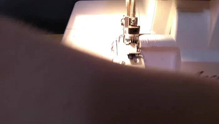 Attach the gathered skirt tiers to the bodice using a serger, placing the ruffle on top for smoother serging.