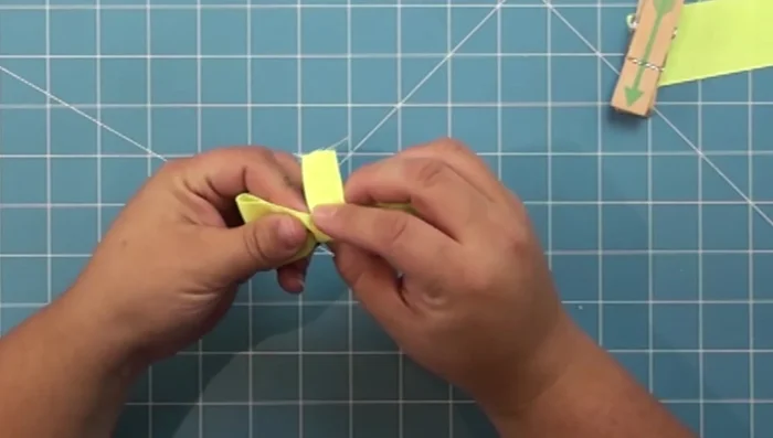 Glue the back of the center piece to the bow, wrapping it around once more and securing with hot glue to create a loop for the collar.