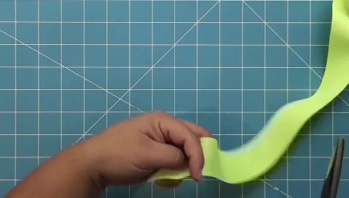 Apply hot glue to the ends of the ribbon and press together to secure.