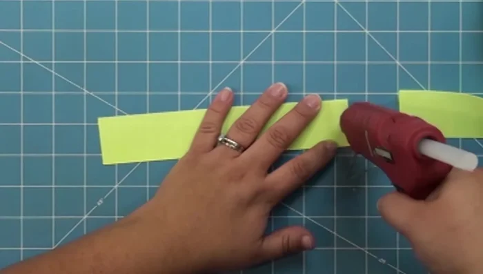 Apply hot glue to the ends of the ribbon and press together to secure.