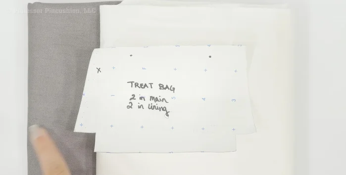 Prepare main fabric. Place twill tape on the X marking of one main fabric piece and baste stitch to secure.