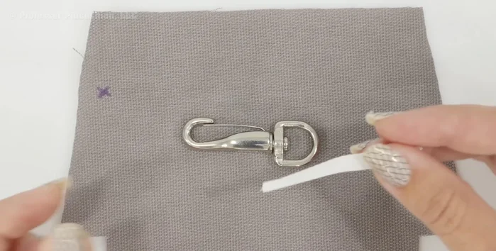 Prepare main fabric. Place twill tape on the X marking of one main fabric piece and baste stitch to secure.