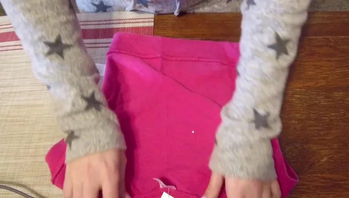 Pinch the center of the shirt to achieve the desired chest width (4 inches). Pin and sew down the center.