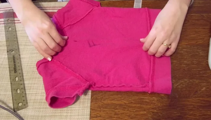Pinch the center of the shirt to achieve the desired chest width (4 inches). Pin and sew down the center.