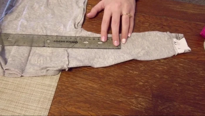Measure and cut the sleeves, ensuring the cuffs fit snugly around the dog's legs. Re-attach cuffs if needed, creating a finished edge.