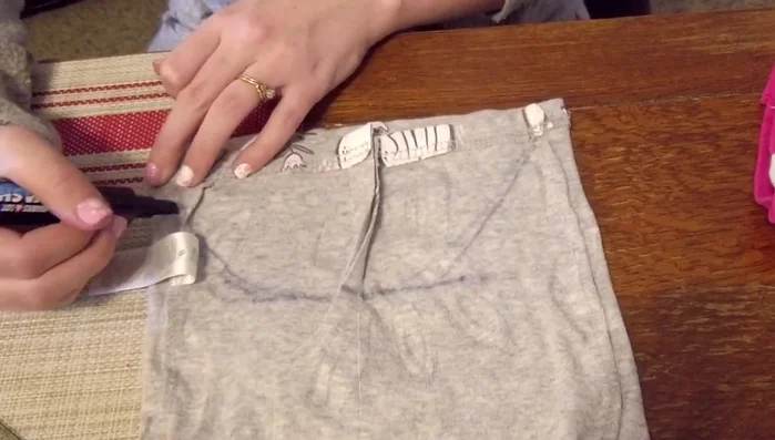 Make an underbelly cutout following previous markings, ensuring evenness. Fold and sew the raw edges to create a finished edge. Cut off any excess seam allowance.