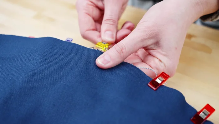 Turn fabric right side out; top stitch around edge, folding openings inward.