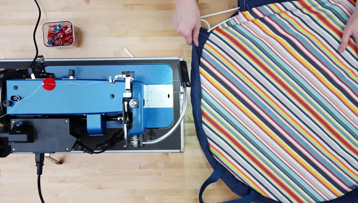 Turn fabric right side out; top stitch around edge, folding openings inward.