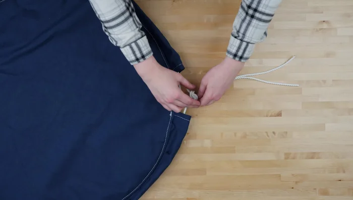 Tie knots on ends of rope.