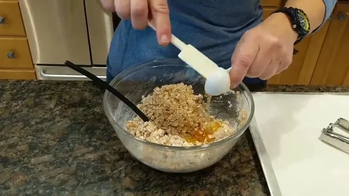 Add 1 tablespoon of honey and mix until the dough holds together.