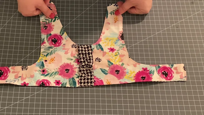 Attach the Velcro. Pin and sew the Velcro closures to the edges of the harness, ensuring they align properly when the harness is fastened.