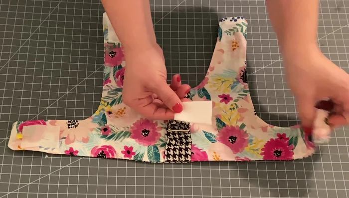 Add embellishments (optional). Hand-stitch a decorative bow or other embellishment above the D-ring.