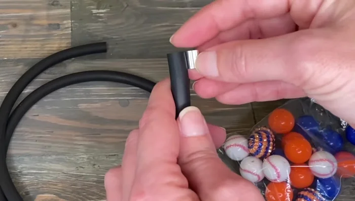 Cut two pieces of rubber tubing slightly longer than the crimp sleeves.