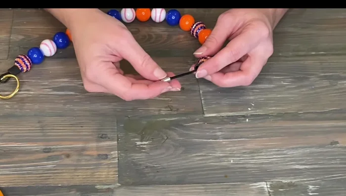 Crimp the sleeve securely, then slide the rubber tubing over the crimp.