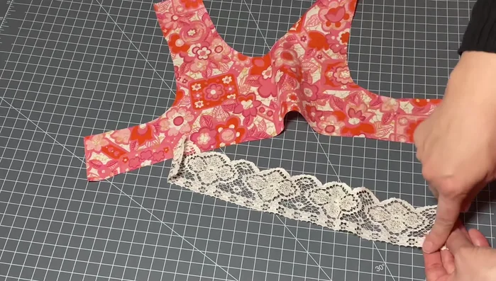 Gather the lace: Use a sewing machine with the largest stitch size and highest tension to create gathers. Alternatively, manually gather using the loose threads.