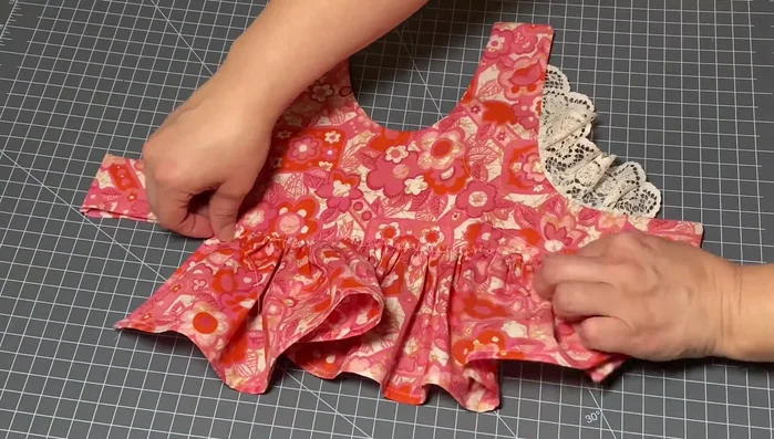 Attach the skirt: Gather two skirt pieces separately. Pin the gathered skirts to the bodice, starting from the center and working outwards. Sew the skirt to the bodice.