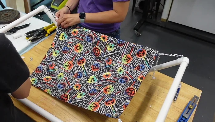 Attach S hooks to the screw eyes and grommets. Attach double loop chain to each corner.