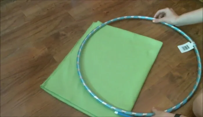 Create the round shape: Fold your fabric into fourths. Use a round object to trace a circle onto the fabric and cut it out. Repeat with the other color.