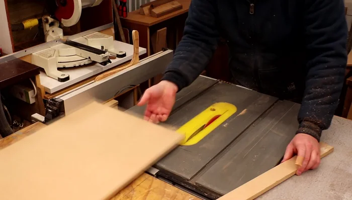Cut cladding pieces from MDF using a table saw at a 45-degree angle, creating slats with consistent spacing.