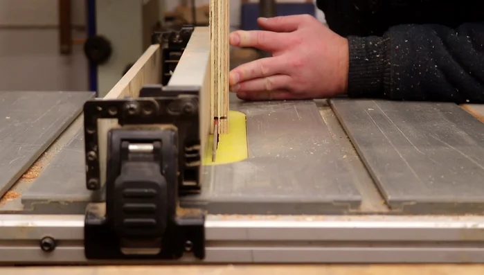 Mark and cut out the arched shapes on the front and back panels simultaneously using a bandsaw for cleaner cuts.