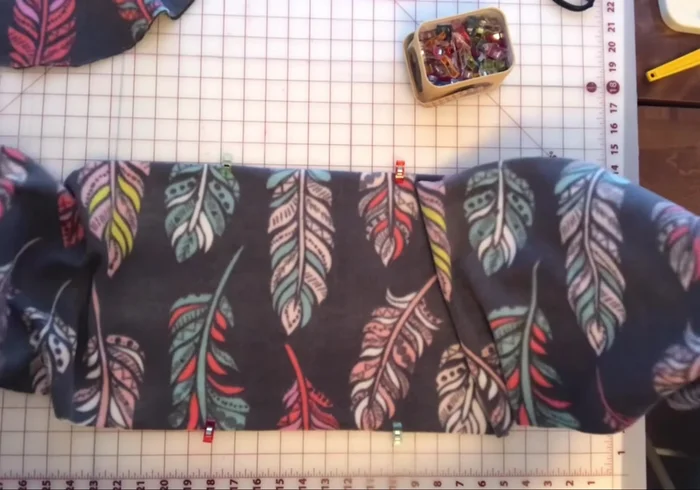 Fold the bolster wrong sides together, flattening the seam. Clip around the edges and stitch closed using an elastic zigzag stitch, leaving the previously zigzagged opening unstitched.