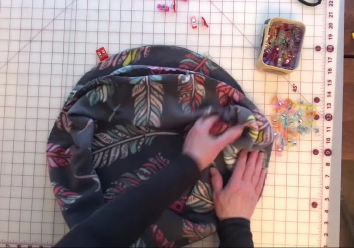 Pin the bolster to the circular base, matching raw edges and openings. Sew together using an elastic zigzag stitch.