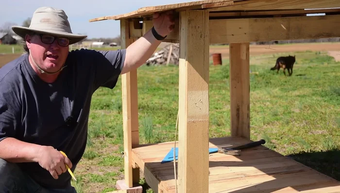 Add wall panels: Cut and attach pallet slats vertically to form the walls. Nail the slats into the existing pallet structure, hiding the nails. Do not worry about perfect fitment; subsequent layers will cover any gaps.