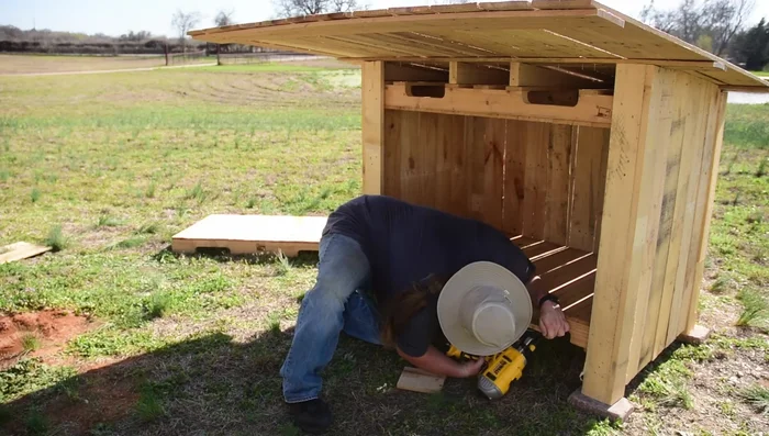 Build the front porch: Attach a board to the front, creating a base for the porch. Measure and cut supporting legs for the porch, ensuring it is level with the main floor. Securely attach the supports.