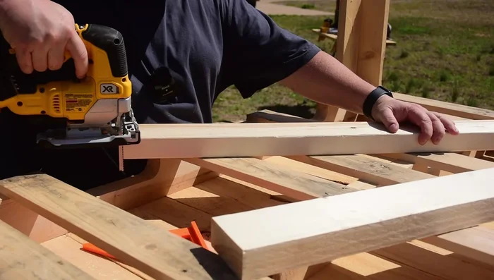 Attach roof boards: Cut side boards to fit against the roof supports. Ensure they're flush with the sides of the roof structure. Then, install the roof boards, ensuring a proper overhang (about 6 inches).