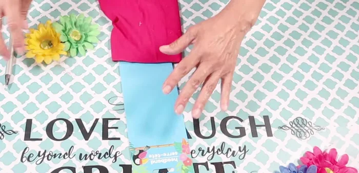 Attach two flowers from the headband to the back of the top using hot glue (sewing is recommended for better durability).