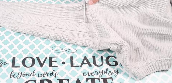 Prepare the sweater sleeve for the sweater top. Cut the sleeve, making it slightly longer than the summer top. Leave the wider end un-rounded.