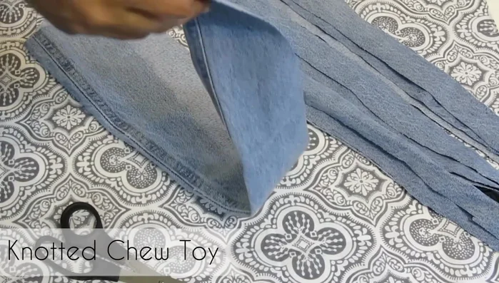 Set aside the strips. Bunch, twist, and knot the remaining larger piece of fabric to create a strong, durable core for the toy.
