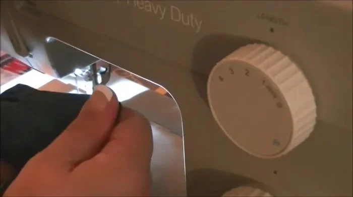 Stuff the toy with filling, placing the squeaker inside with some padding around it for protection.