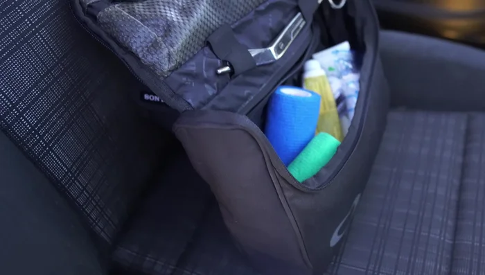 In the front, set up a first-aid kit and water for both the handler and dogs.