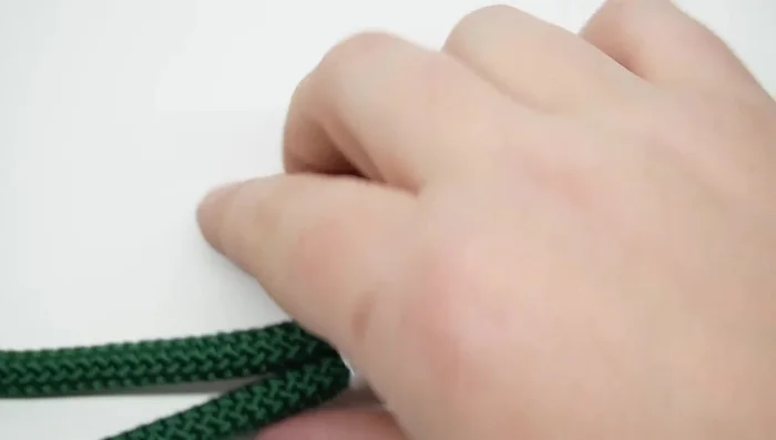 Seal the ends of the paracord on both the clip and handle sections using a lighter and smoothing tool.
