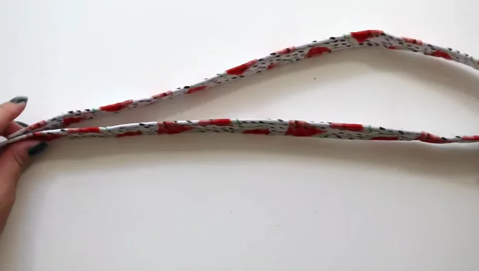 Assemble the collar: Attach the tri-glide to the middle of the strap. Pull the strap through the tri-glide, then under and over the pronged side of the buckle.